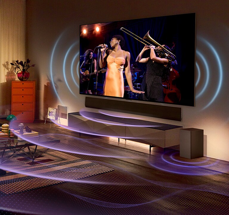 Snímek LG OLED TV v místnosti, na které je hudební koncert. Prostor vyplňují modré zakřivené čáry znázorňující zvuk televizoru a fialové zakřivené čáry vyjadřující zvuk soundbaru Soundbar.