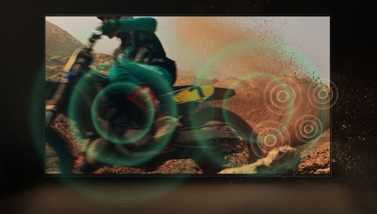 A video of a person dirt biking on red, dusty land. As they take a corner, green sound bubbles appear from the wheel. 	
