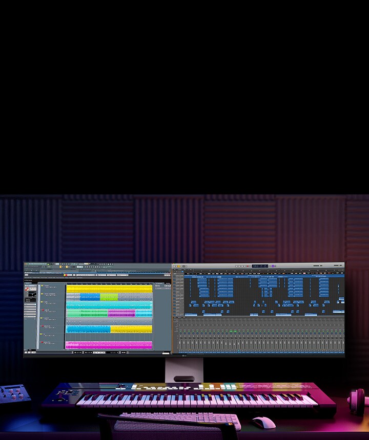 Nastavení pro produkci hudby s monitorem LG UltraWide, který zobrazuje vrstvené zvukové stopy a kompletní časovou osu projektu.