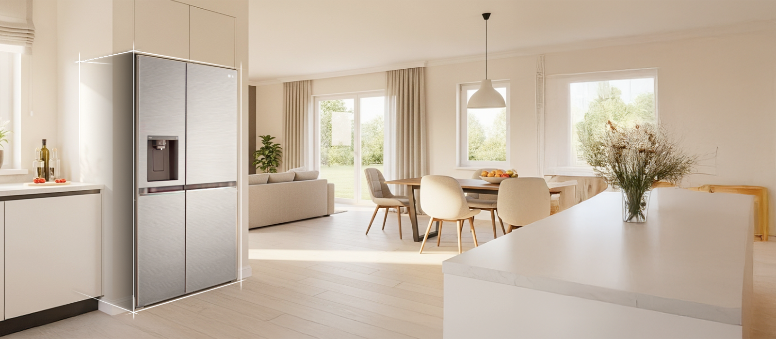 Bright beige-toned kitchen interior with a silver LG fridge freezer built into the left side. On the right, a dining table with flowers placed on top completes the scene.