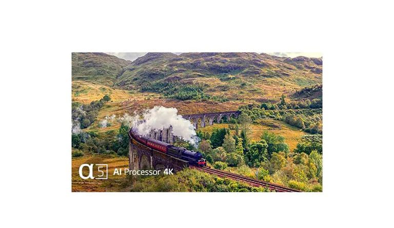 A train giving off steam on the rail is in the middle of the mountain with the text of 'Quad Core Processor 4K' on the bottom left.