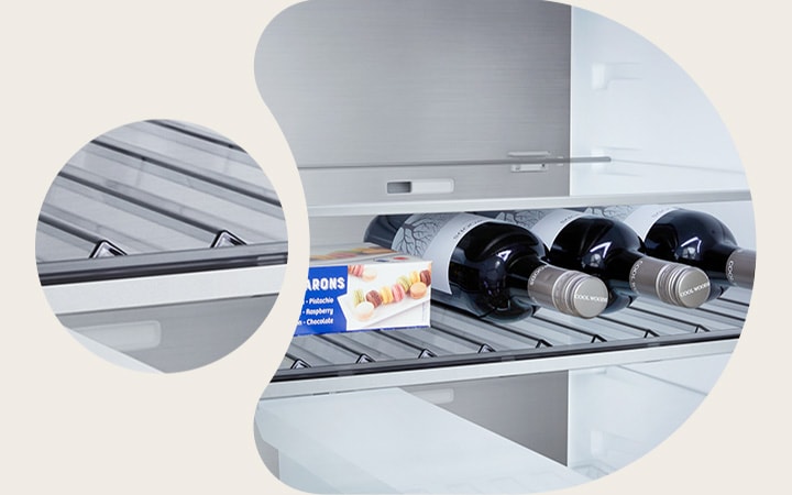 Nahaufnahme des LG Kühl-/Gefrierschrank (GBBS726CPY) Weinregals mit vier Flaschen und einer Schachtel Macarons mit im kreisförmigen Bild vergrößertem Gestelldesign