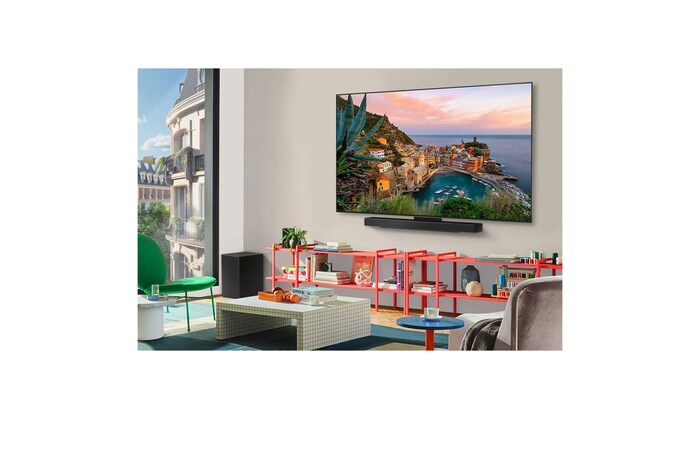Wide view of a stylish and colorful living room. LG OLED evo AI C5 4K Smart TV is mounted on the wall with an LG Soundbar underneath it. The TV's design blends well with the space. On the TV screen is a colorful artwork.