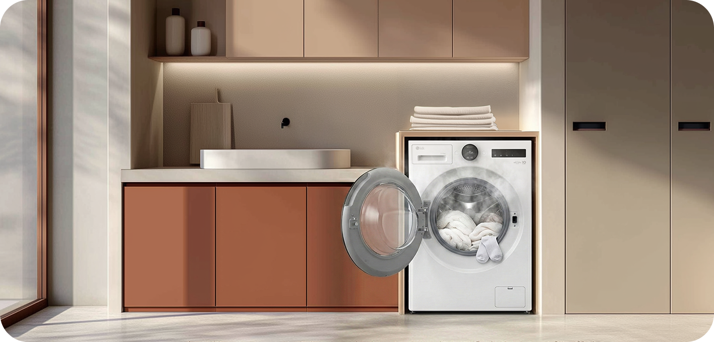 A white front-loading washing machine is built into a cabinet space, with folded towels placed on top.