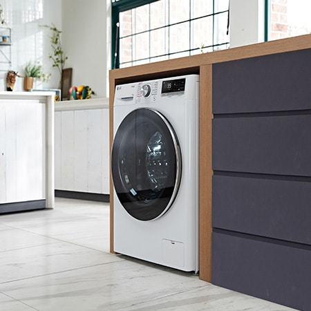 Die weiße LG 11 kg Waschmaschine F4WR7011 mit elegantem Design, installiert in einem modernen Waschraum, mit Energieeffizienzklasse A-10%.