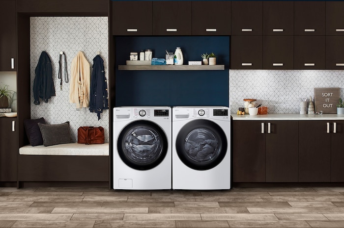 Der weiße LG Trockner RT18VT als Teil eines passenden Wasch-Sets, nebeneinander in einem modernen Waschraum installiert, mit Energieeffizienzklasse D.