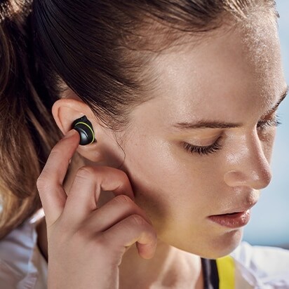 Image of woman wearing ToneFree in her ear.