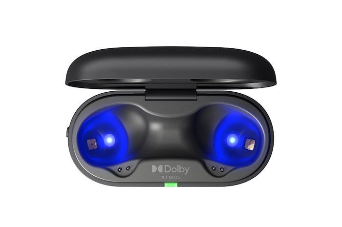 The earbuds float in the air above the open cradle with the light on.