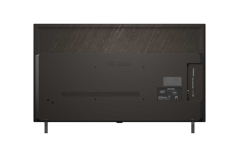 Bred visning af en luksusstue i matte jordnuancer. På væggen er der et LG OLED AI B5 4K Smart TV med et kunstværk på skærmen. En LG Soundbar er monteret under det. 