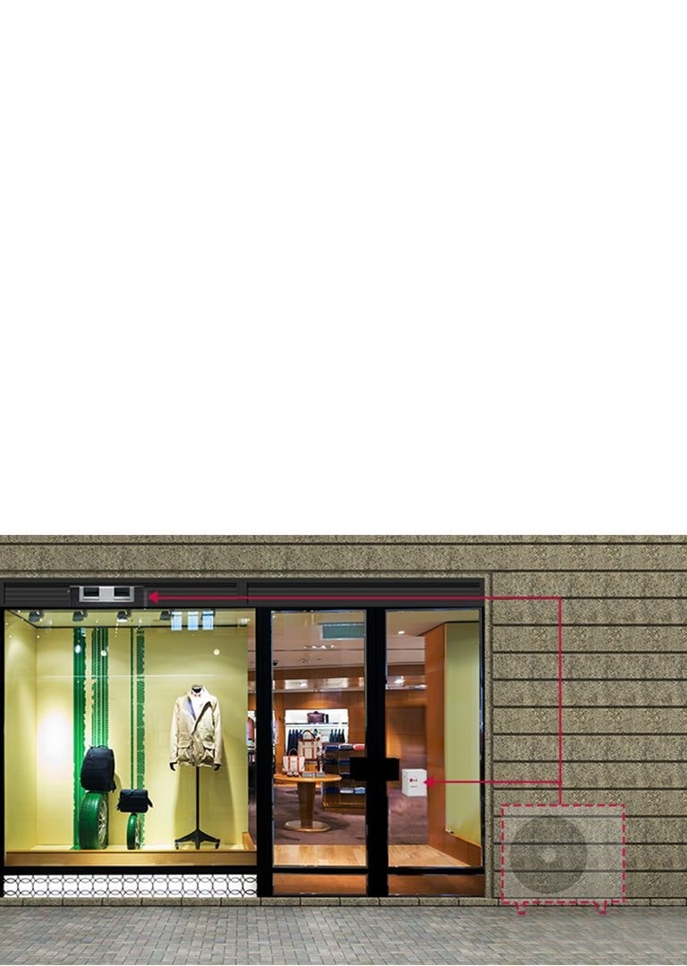 MUlTI V M installeret i loftet af en butik med herretøj. Utydeligt billede af en udendørsenhed, som er forbundet med en indendørsenhed i butikken. 