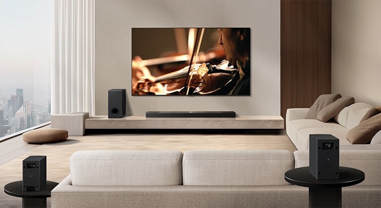 LG Soundbar, LG TV, en bashøjttaler og baghøjttalere i moderne bylejlighed. Baggrunden dæmpes, og på LG TV'et fremkommer et overlejret gitter, der ser ud som om, at det scanner rummet. En stiplet linje strækker sig fra en af baghøjttalerne for at vise, at de to baghøjttalere er anbragt på en lineær måde. Hvide lydbølger af små dråber kommer ud af baghøjttalernes frontperspektiv.