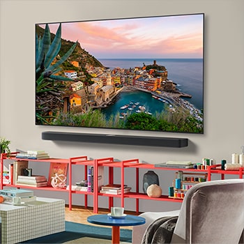 Wide view of a stylish and colorful living room. LG OLED AI CS5 4K Smart TV is mounted on the wall with an LG Soundbar underneath it. The TV's design blends well with the space. On the TV screen is a colorful artwork.