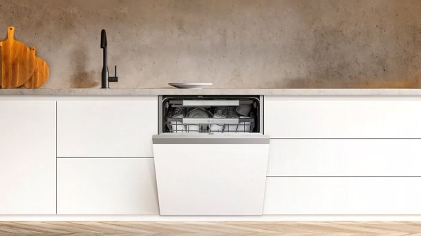 LG white Integrated Dishwasher in a minimal kitchen with white cabinetry and open door revealing loaded racks beneath a countertop.