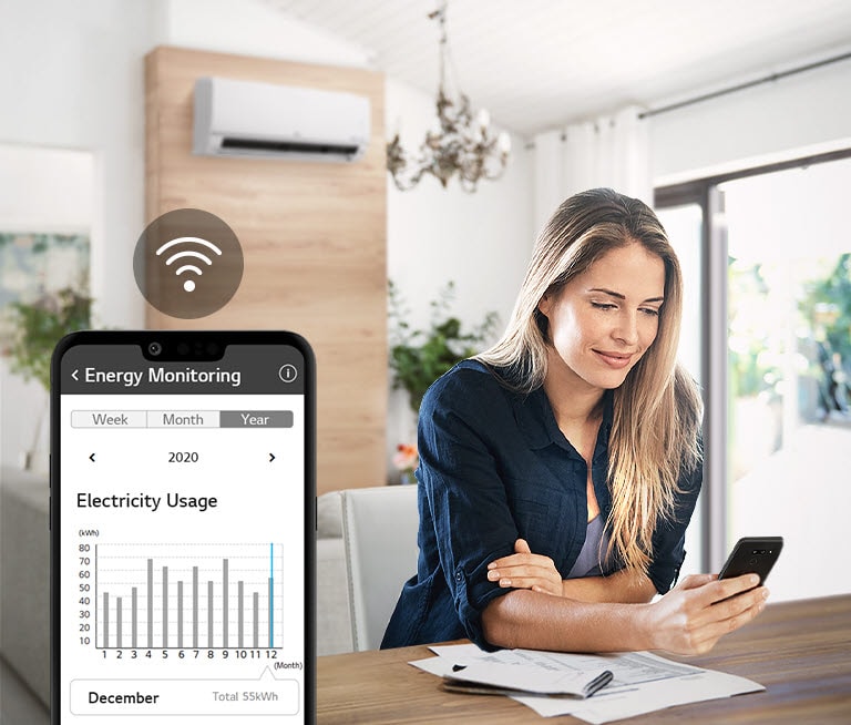 Woman reviewing electricity usage on smartphone at a table, with an air conditioner and large window in the background.