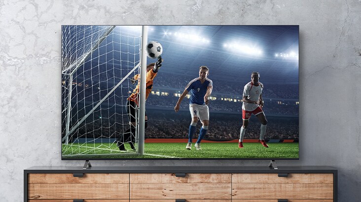 The soccer game scene shown on the TV screen appears real.	