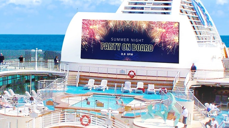 People are enjoying swimming in the cruise’s pool, and a large LED is hanging on the walls on board. The LED screen is promoting the cruise’s Summer Night Party that will be held on the cruise.