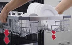  Hands placing white dishes into the upper rack of an open LG dishwasher with red arrows indicating movement direction.