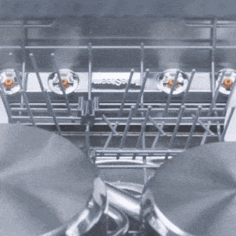Dishwasher interior with TrueSteam removing spots and cleaning dishes.	