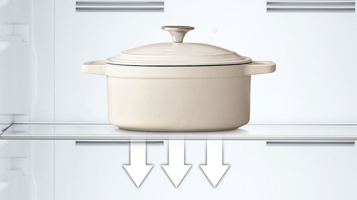 Tempered glass shelf holding heavy pot inside refrigerator, showing its strength and easy-to-clean surface