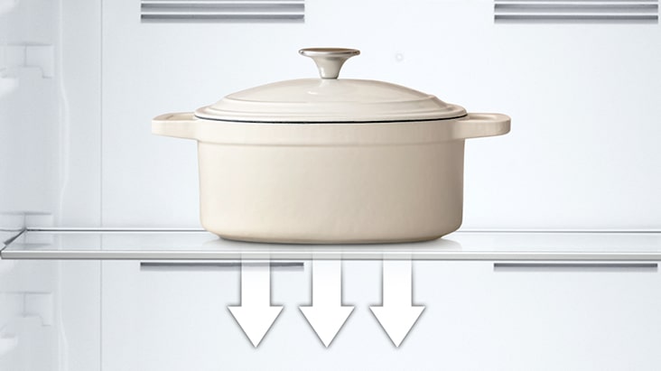 Tempered glass shelf holding heavy pot inside refrigerator, showing its strength and easy-to-clean surface