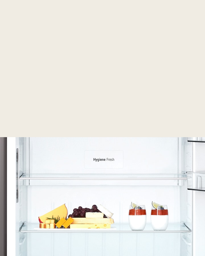 Close-up of an LG top freezer showing the Hygiene Fresh compartment with fruit to show its fresh-keeping function.