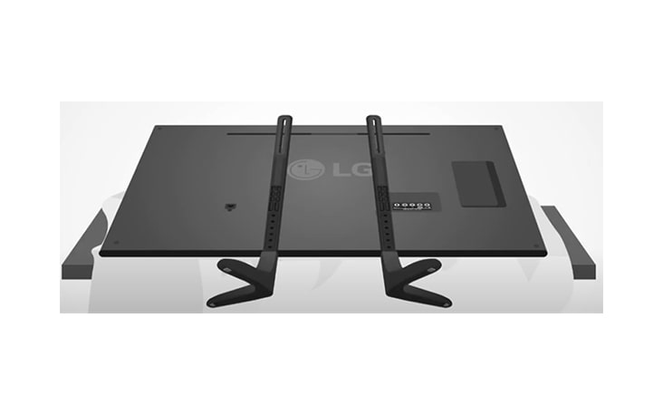 Coloca un cojín o un paño suave en una mesa y colocar el monitor sobre él, con la pantalla hacia abajo