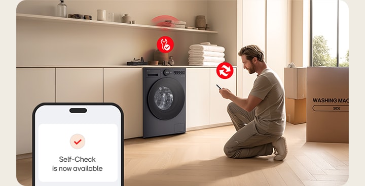 Hombre instalando una lavadora LG en en la cocina utilizando la función autodiagnóstico del teléfono 