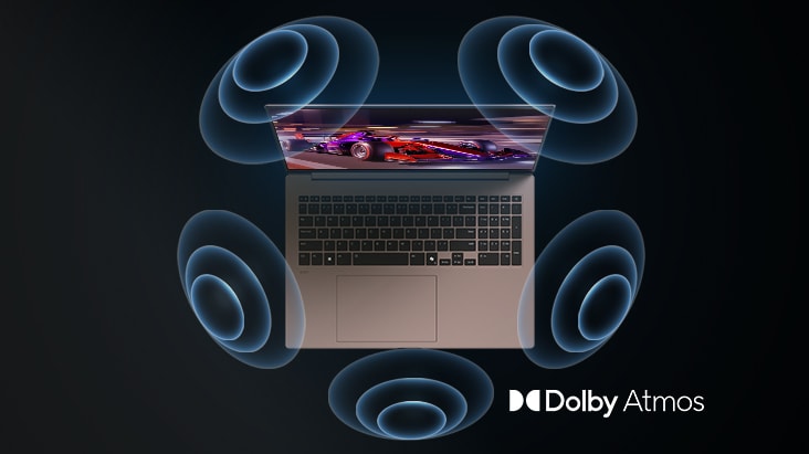 'La imagen muestra una vista cenital de un portátil con un gráfico vibrante en tonos púrpura en la pantalla. Alrededor del portátil aparecen visuales dinámicos de ondas sonoras, que indican una experiencia de audio inmersiva. El logotipo de ‘Dolby Atmos’ se muestra en la esquina inferior derecha.