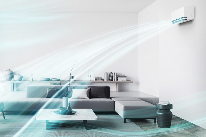 Elegante salón con aire acondicionado LG que utiliza tecnología de doble aleta para proporcionar un flujo de aire más rápido en todo el espacio.