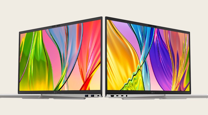 L’image présente deux ordinateurs portables dos à dos, présentant des écrans éclatants et colorés avec des cadres fins, mettant l’accent sur des visuels éclatants et un design élégant.