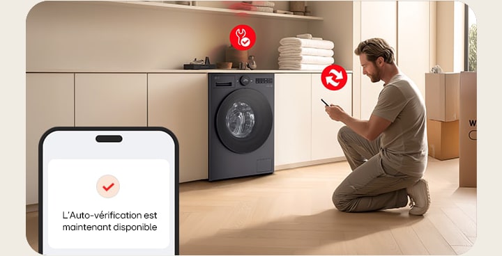 Man installing LG washer in laundry room using phone self check feature with box and folded towels nearby