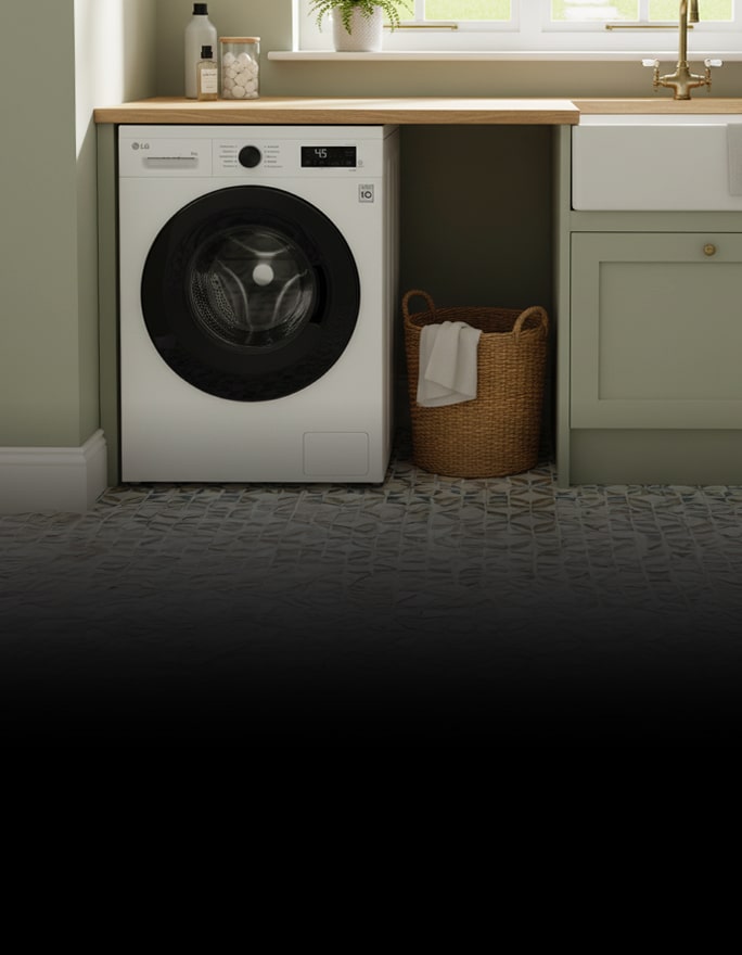 A white front-loading washing machine is built into cabinetry, placed next to a laundry basket, with its control panel and circular door visible.