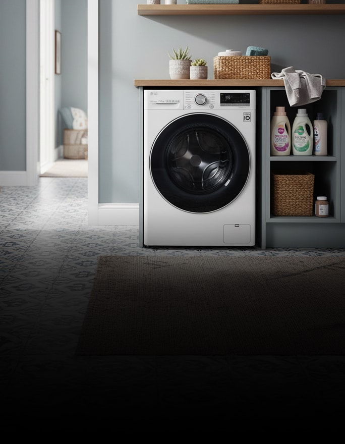 A white front-loading washer sits beneath a wooden shelf, surrounded by neatly placed towels and decor.