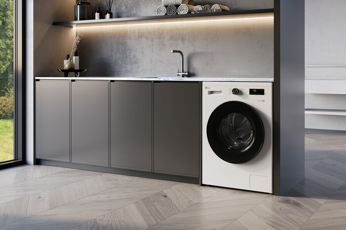 Lave-linge séchant LG F94B16WHS blanc installé sous un plan de travail moderne, doté d'un hublot noir élégant.