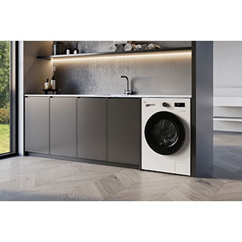 Lave-linge séchant LG F94B16WHS blanc installé sous un plan de travail moderne, doté d'un hublot noir élégant.