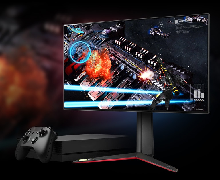 Moniteur 27GP950 avec un jeu de tir affiché à l'écran et une console de jeu à côté.