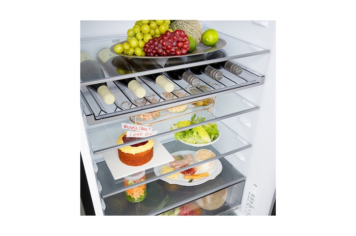 LG fridge freezer (GBBW726AEV) built into dark brown cabinetry with window and sofa on left and sink on right