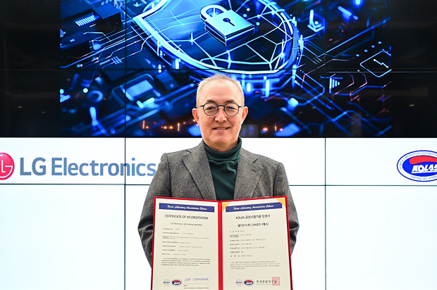 LG Electronics executive holding certificate of accreditation for cybersecurity, with digital security graphic in background