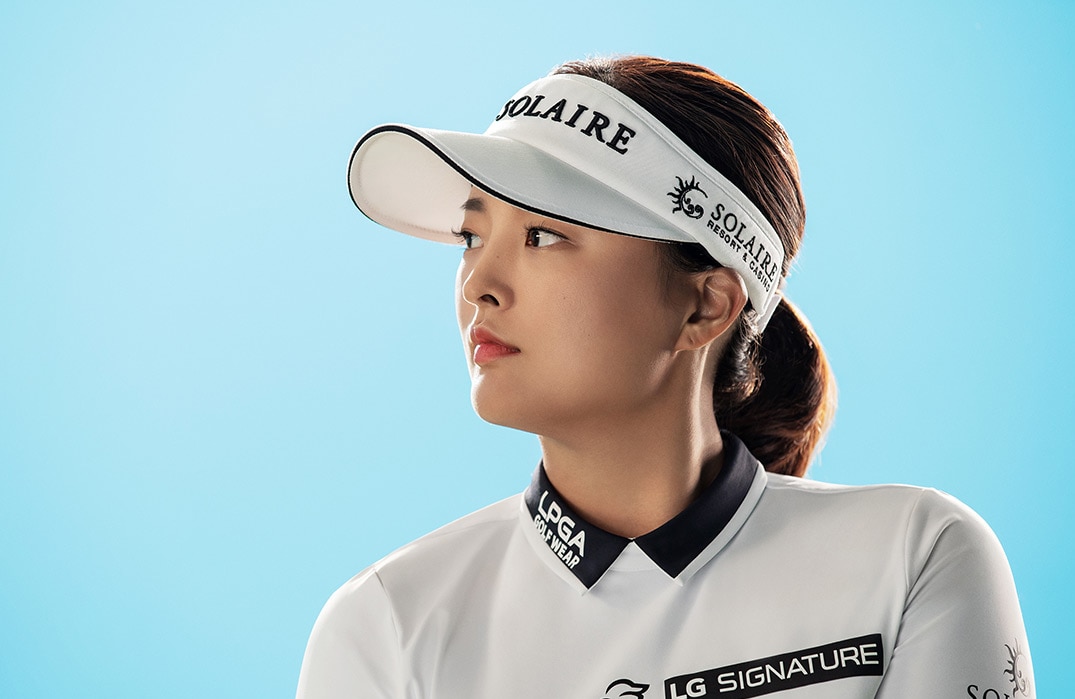 LG SIGNATURE brand ambassador Jin Young Ko looks at something.