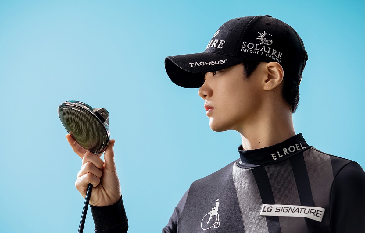 LG SIGNATURE brand ambassador Sung Hyun Park looks at her golf club.