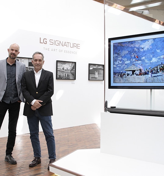 two men are standing in front of lg signature oled tv at launching event in colombia