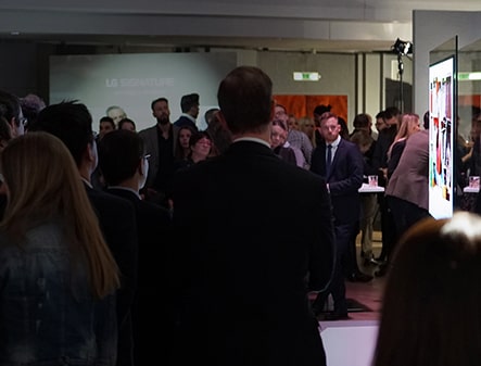 many people are standing and staring lg signature oled tv at artweek in germany