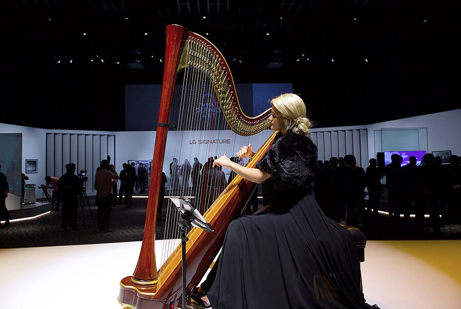 a woman plays a musical instrument at launch event in dubai