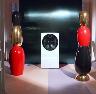 lg signature washing machine is displayed in the middle of the space wth some artistic sculptures on both side at the lg signature artweek in spain