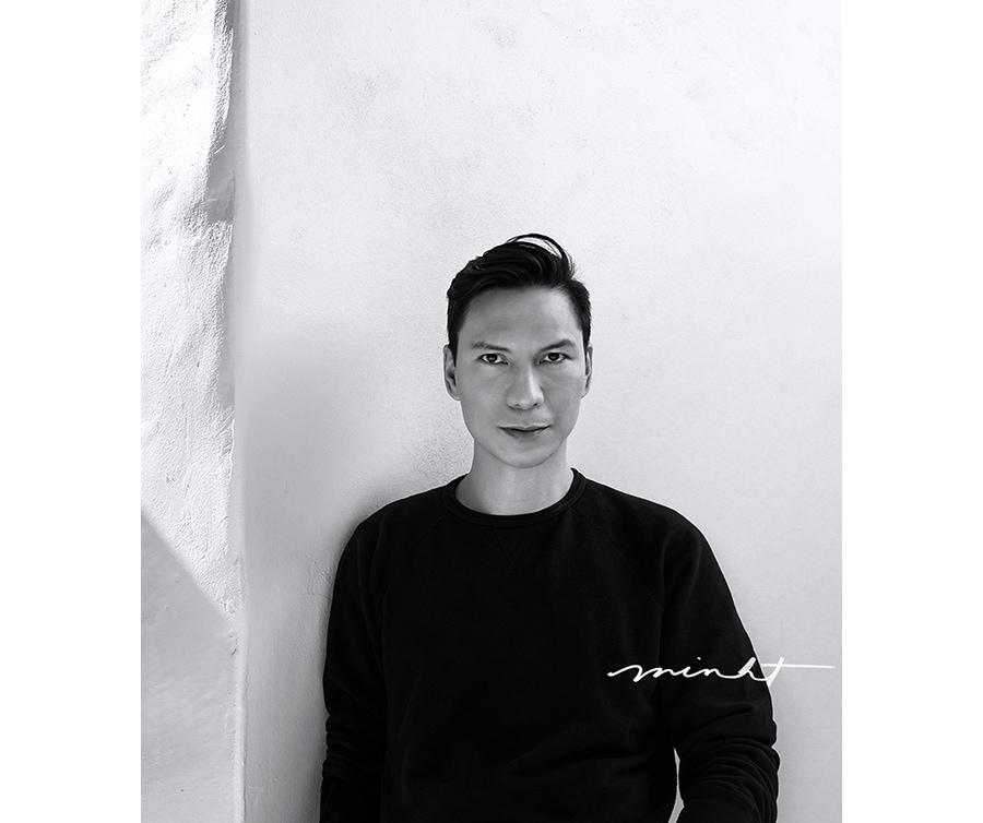 a black and white profile image of creator minh tran with his autograph printed on the right side