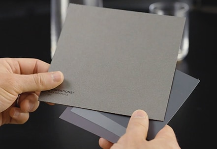 close shot of darren palmer's hands holding a metalic gray color palette chips