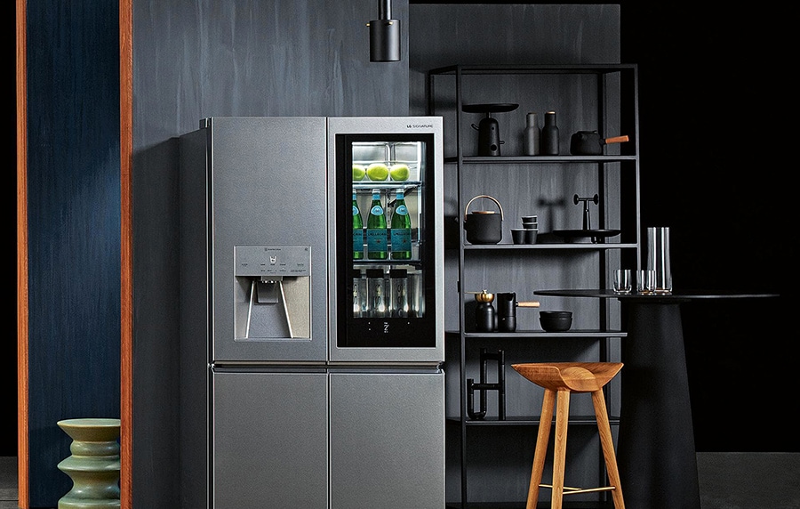 lg signature refrigerator is displayed in the gray tone kitchen with its instaview light turned on