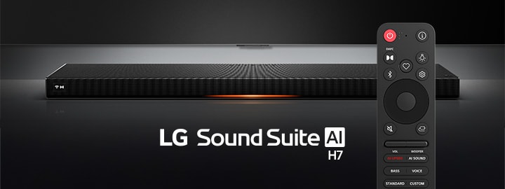 LG Sound Suite H7 soundbar with a slim, sleek black design displayed on a surface under a spotlight. Its remote stays in front of it.