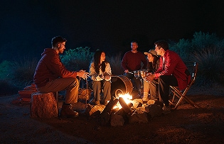 People enjoying camping with smiles, embracing the power of optimism.