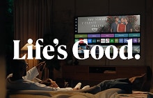 A couple relaxing on a bed while watching the webOS screen on an LG OLED evo AI TV, with "Life's Good." text overlay.